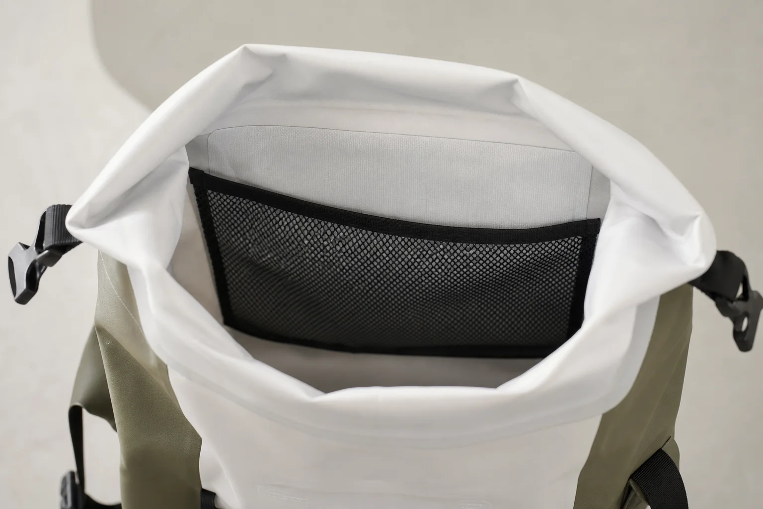 Interior view of pannier showing mesh pocket and roll-top closure
