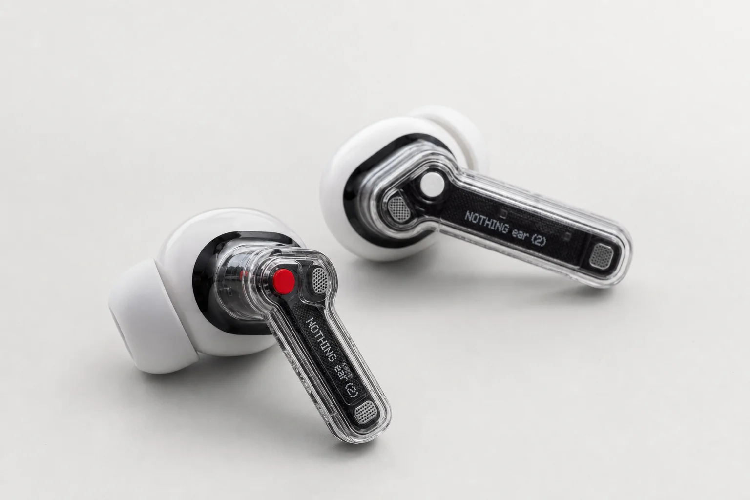 Collection of 12 true wireless earbuds arranged on concrete surface