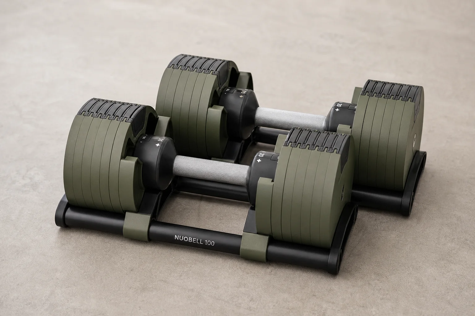 Seven different adjustable dumbbell models arranged on concrete surface