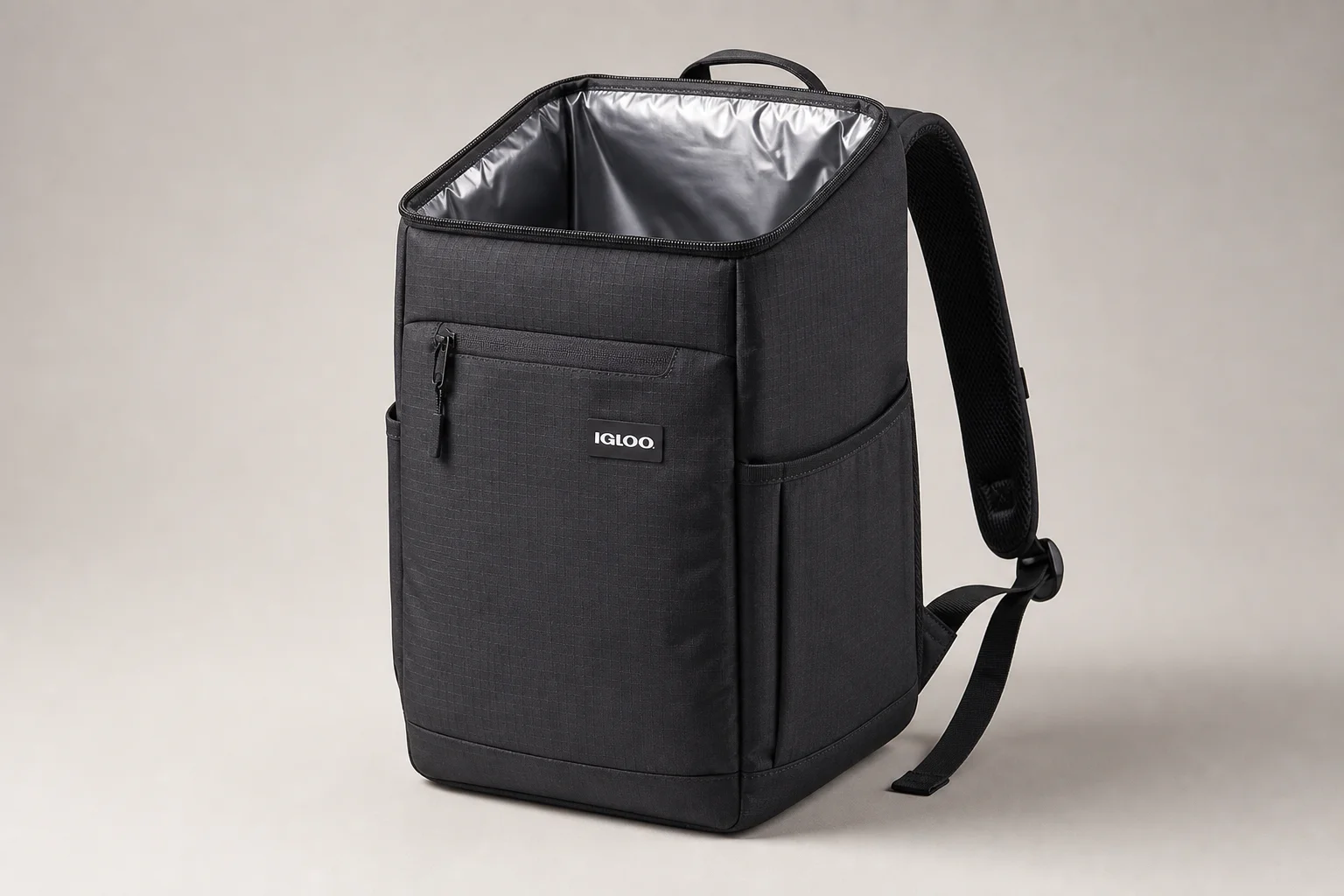 Five cooler backpacks in various styles arranged on concrete surface