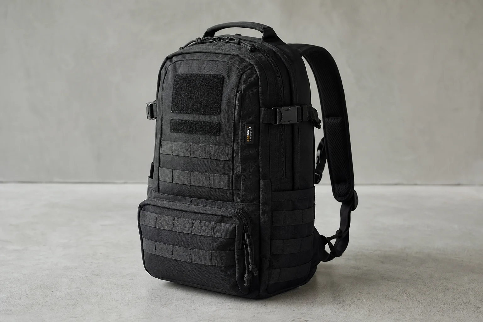 Five waterproof backpacks lined up on concrete surface showing different designs and materials