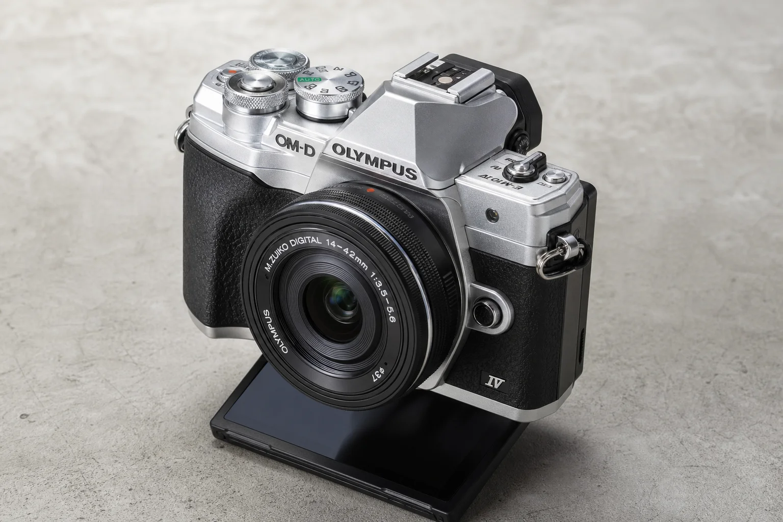 Five mirrorless cameras arranged on neutral backdrop: Sony ZV-E10, Olympus OM-D E-M10 Mark IV, OM System OM-5, Sony Alpha 7C II, and Fujifilm X-T5
