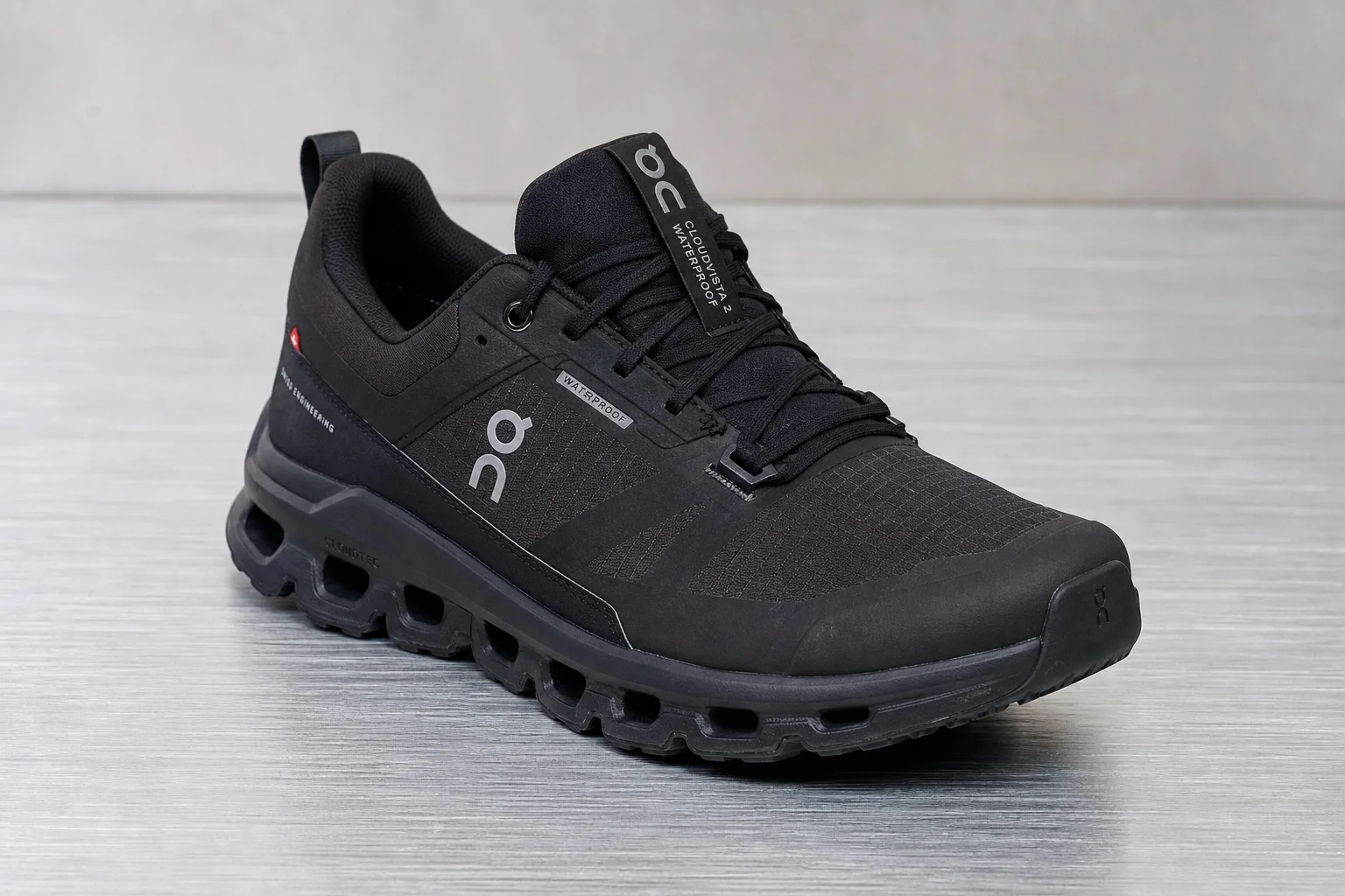 Five hiking shoes arranged in a row on concrete surface