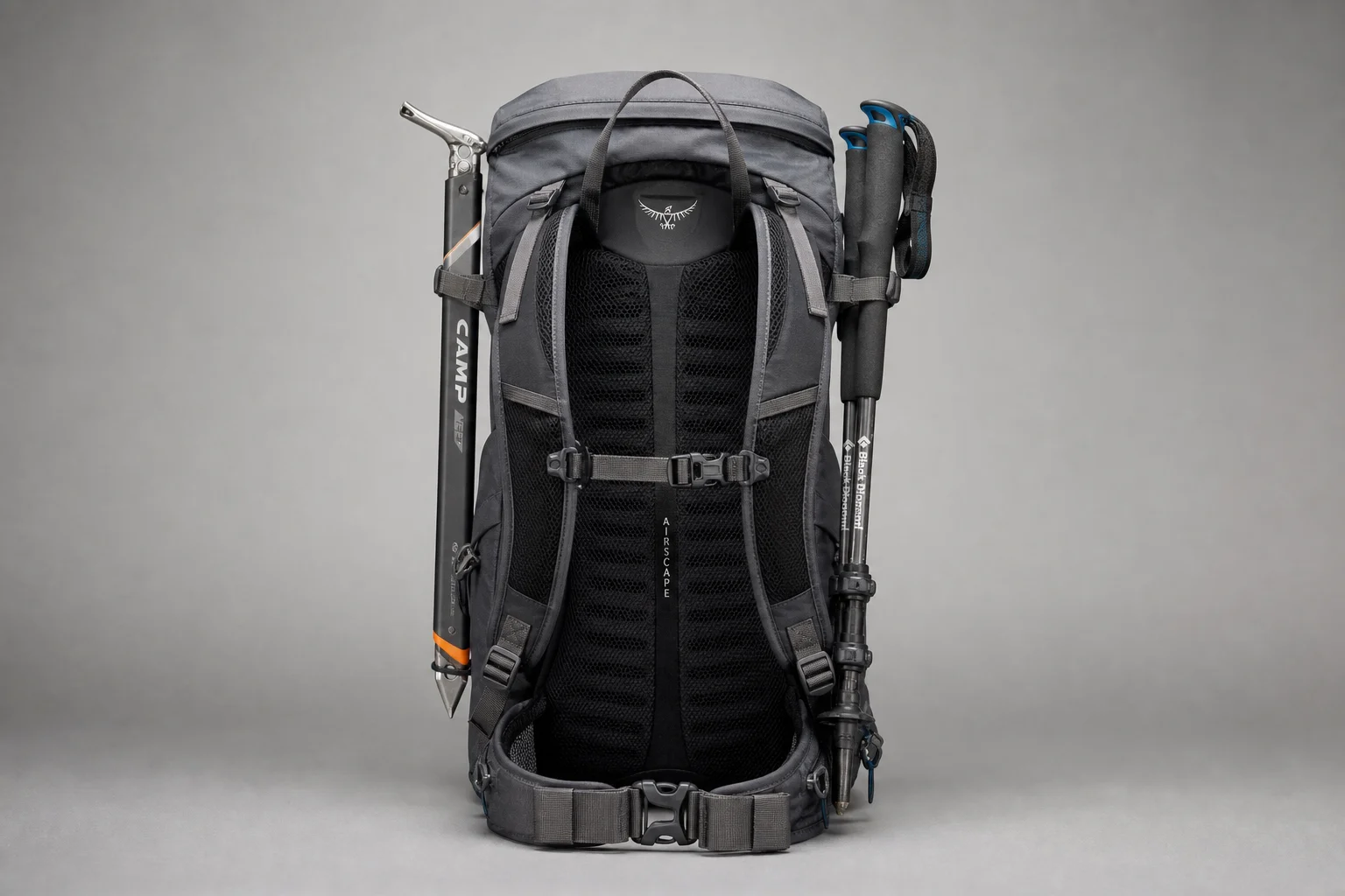 Backpack with ice axe attachments and pole storage system displayed on neutral surface
