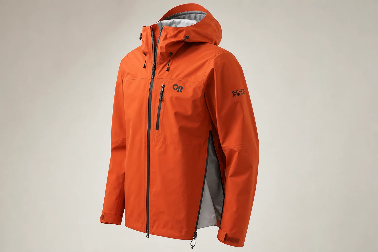 Five waterproof jackets in different colors and styles arranged on concrete