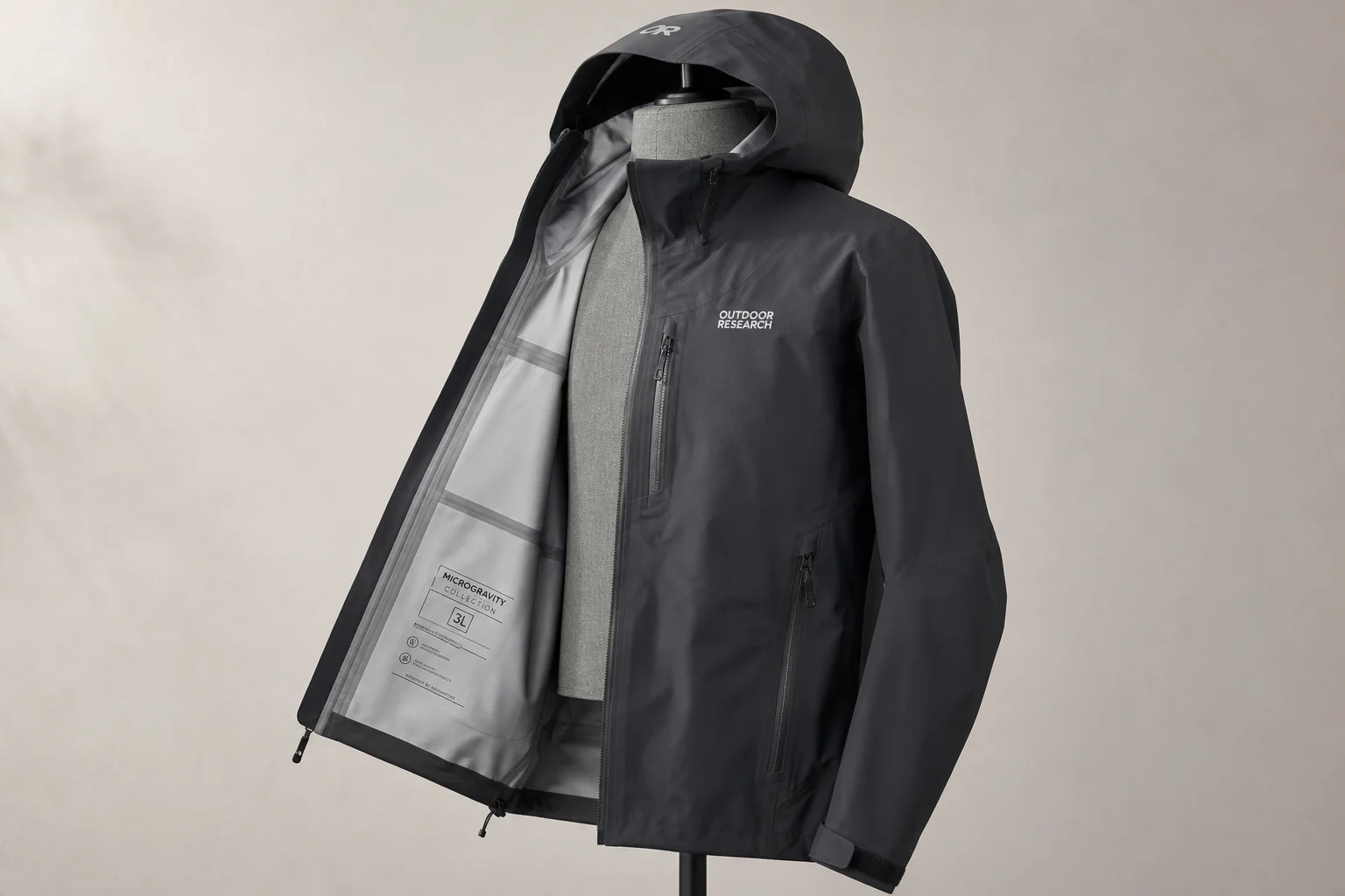 Five waterproof jackets in different colors and styles arranged on concrete