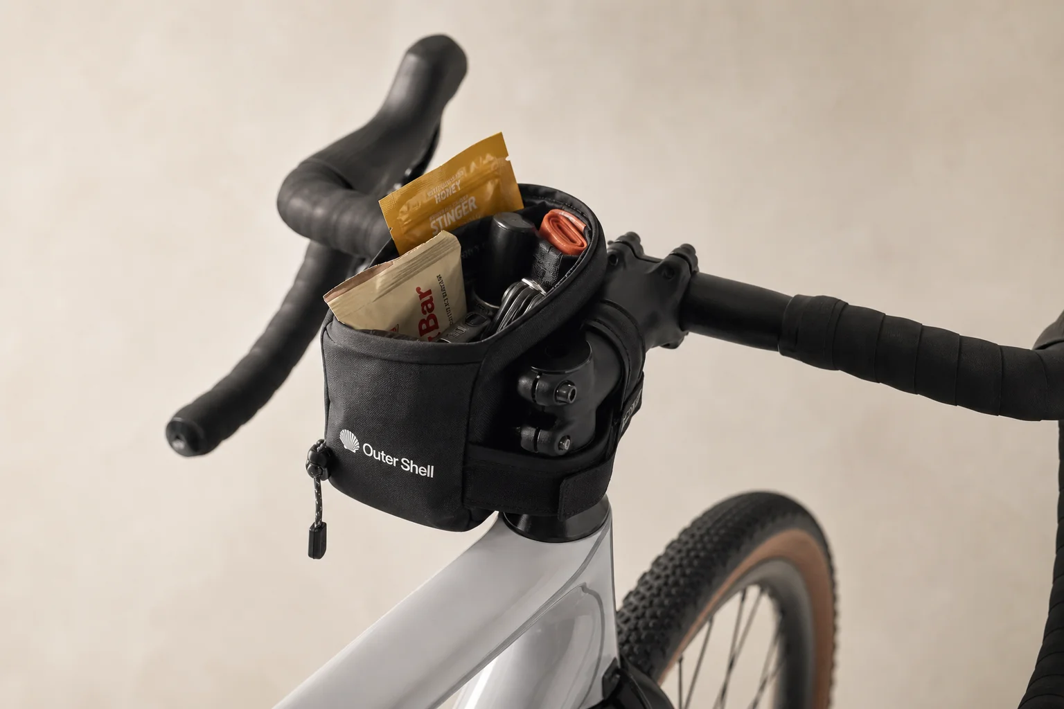 Stem caddy mounted on bike stem area with snacks and gear visible inside