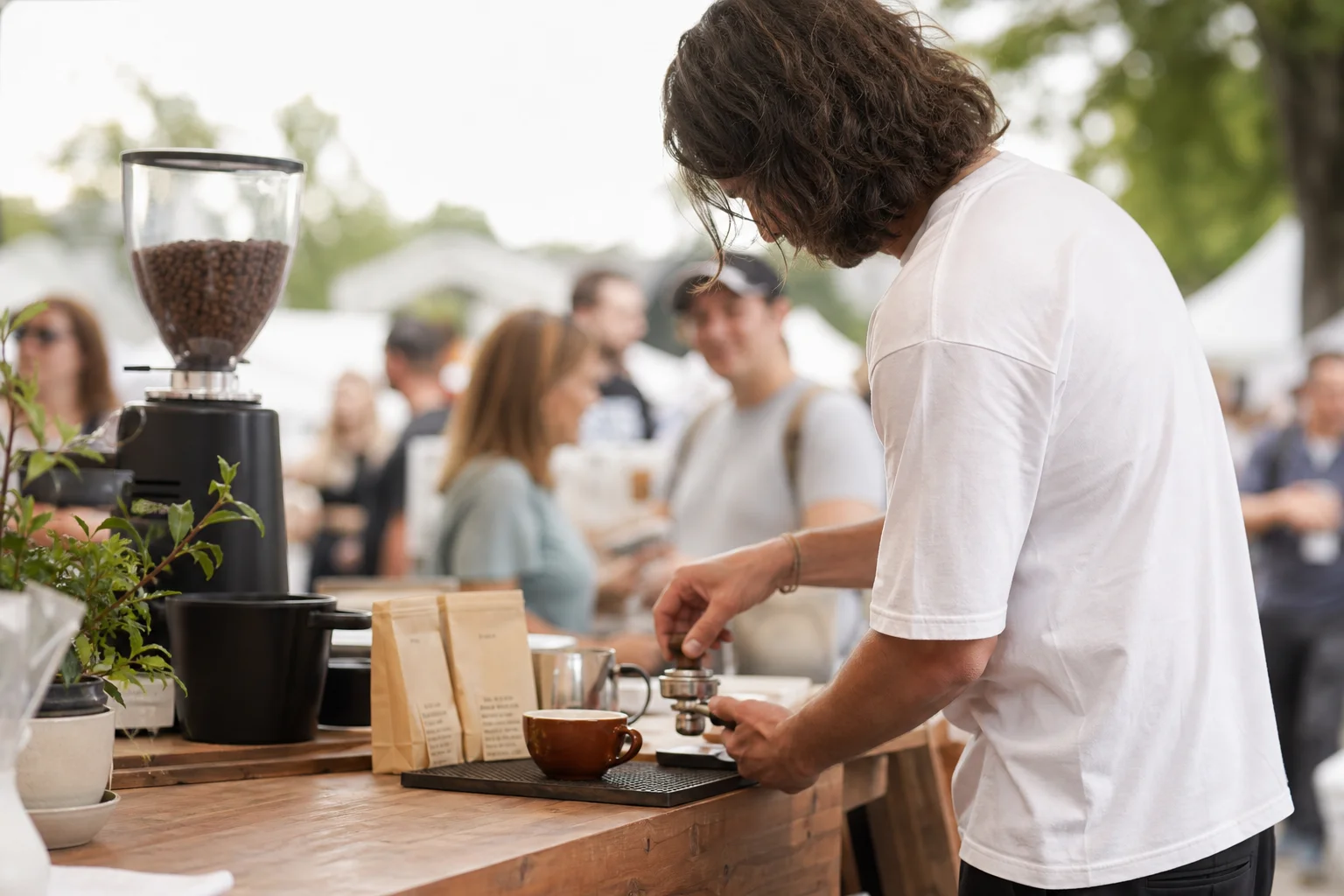 Barista pouring espresso at an outdoor coffee festival event