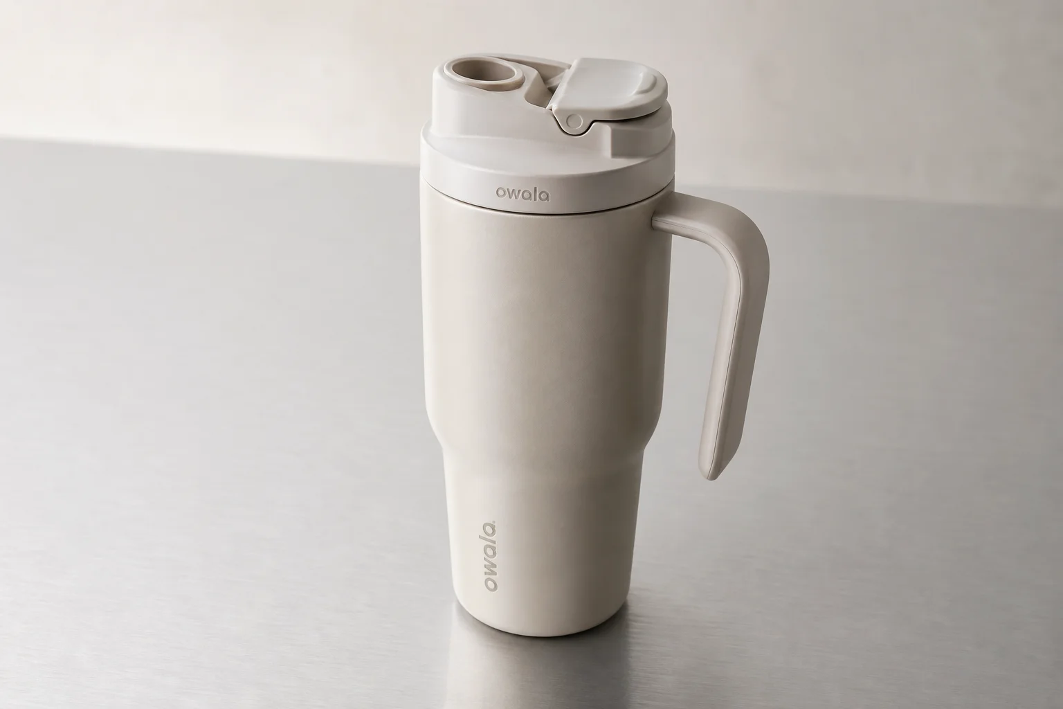 Six insulated water bottles from different brands arranged on concrete surface