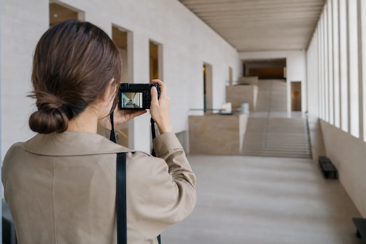 Travel photographer framing a wide architectural shot with a compact camera