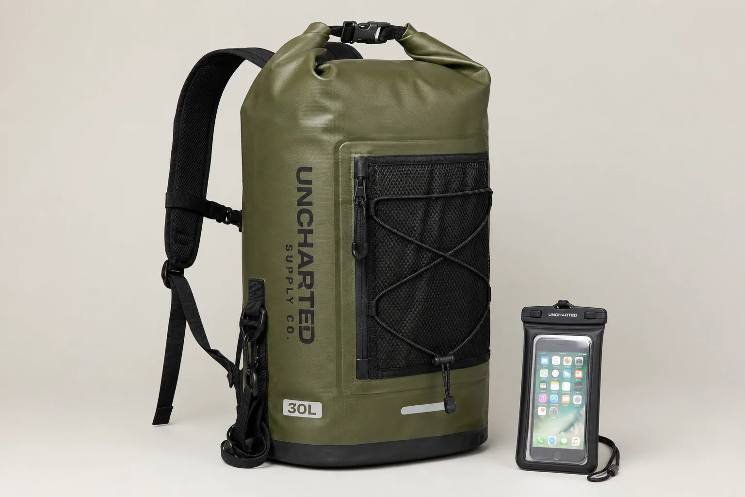 Five waterproof dry bags in various sizes and colors arranged on concrete