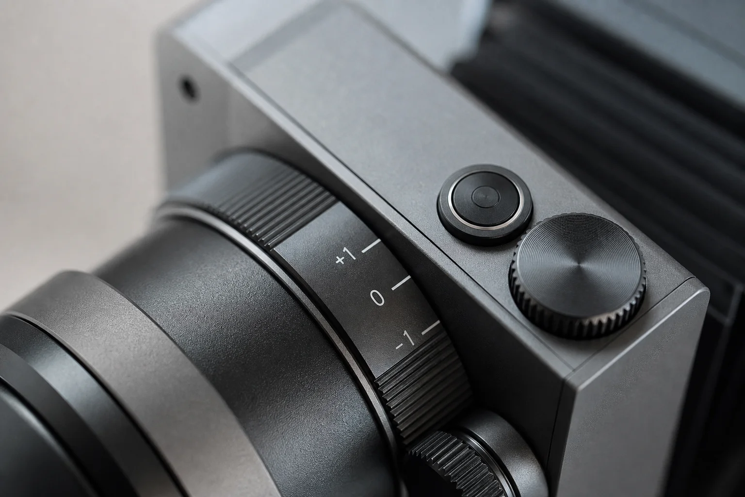 Close-up detail of the Polaroid I2 lens barrel showing exposure compensation dial and mode controls