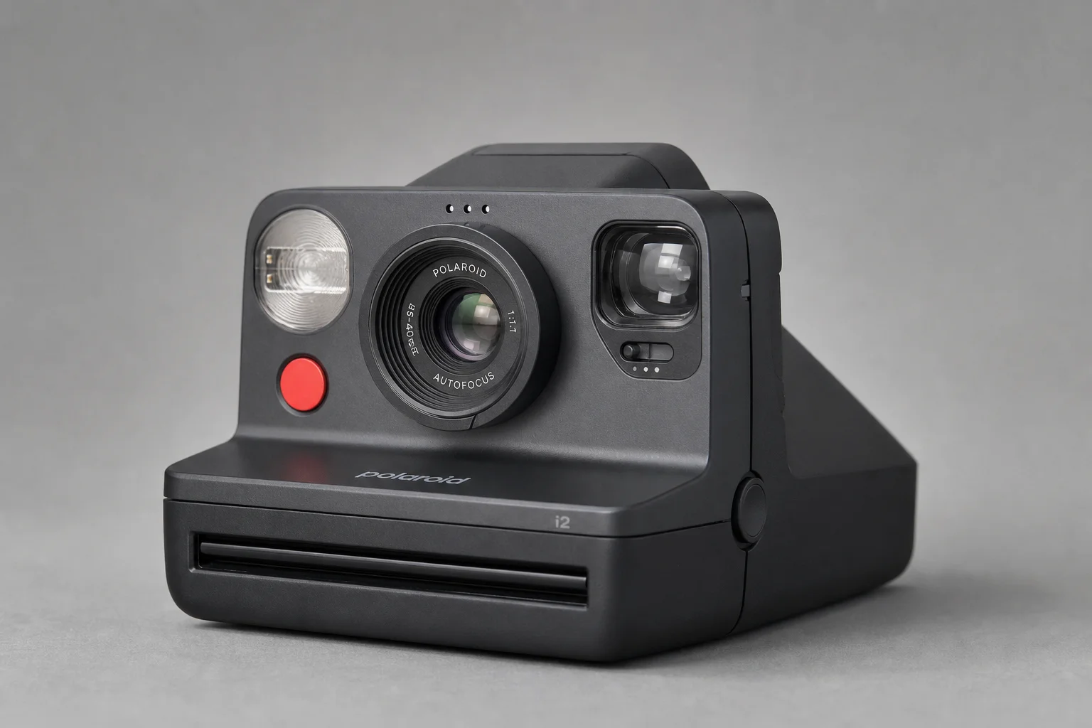 Polaroid I2 instant camera with red shutter button on neutral grey backdrop