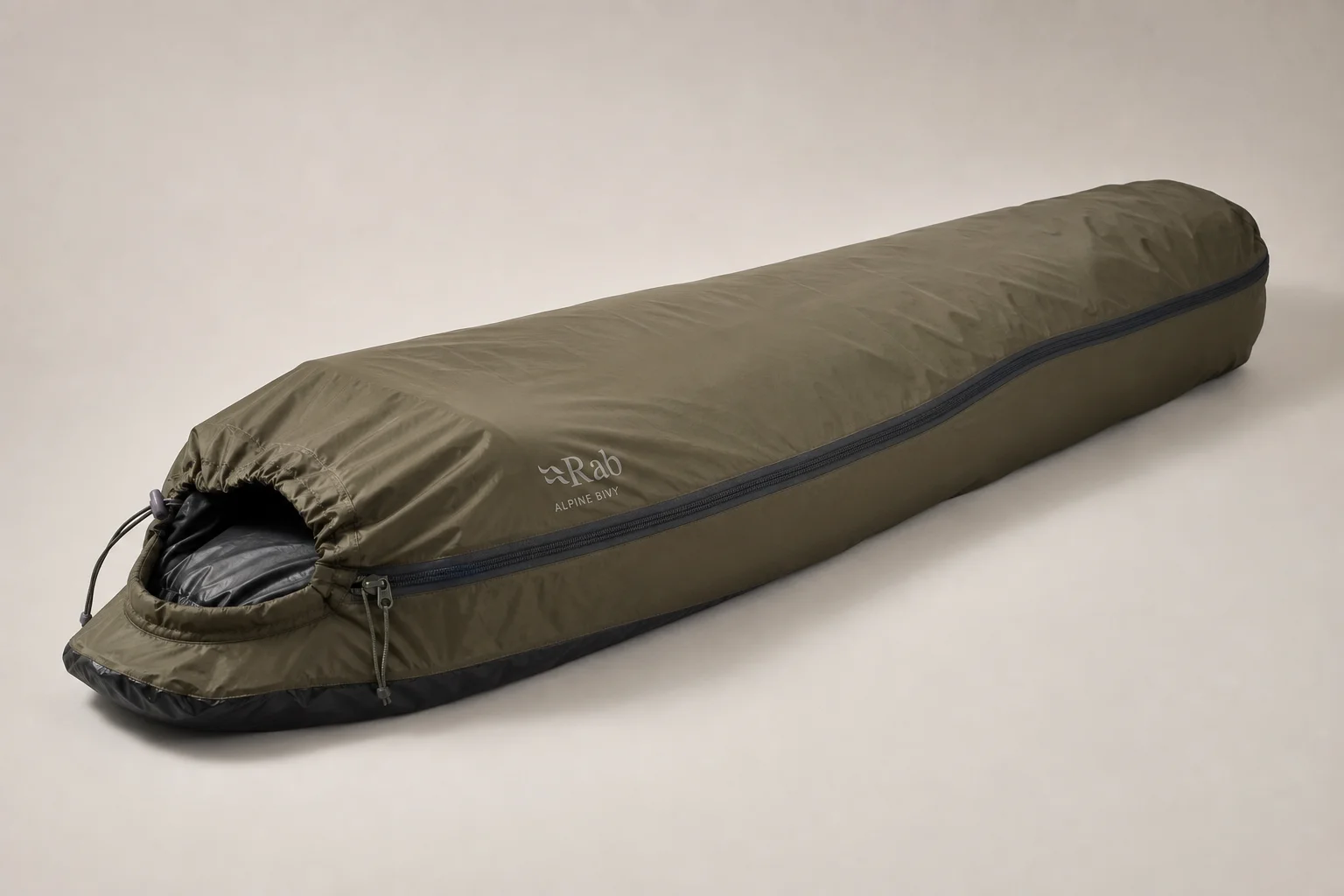 Five bivvy bags displayed in a row on concrete surface showing different designs and colors
