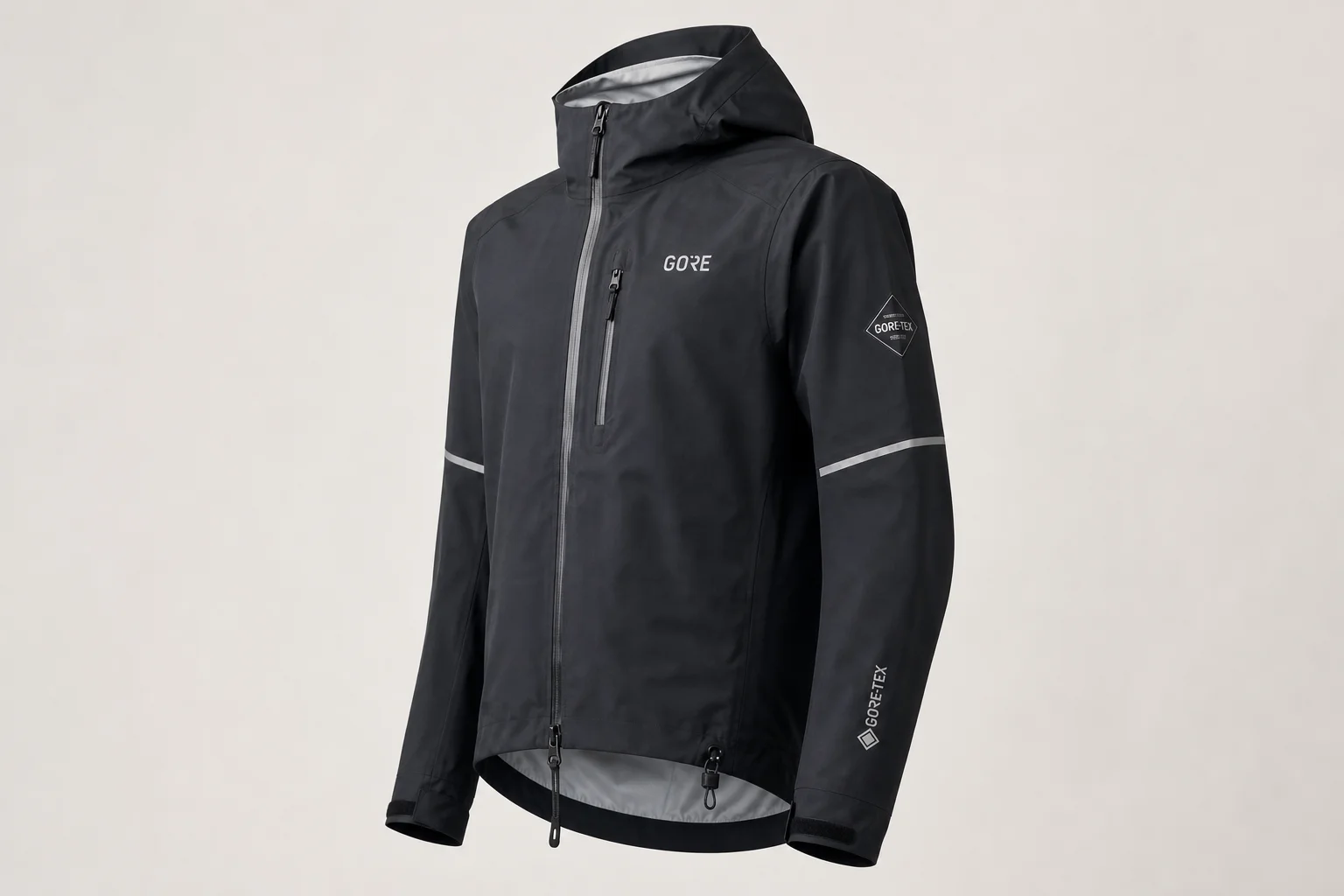 Five cycling rain jackets in various colors arranged on neutral backdrop