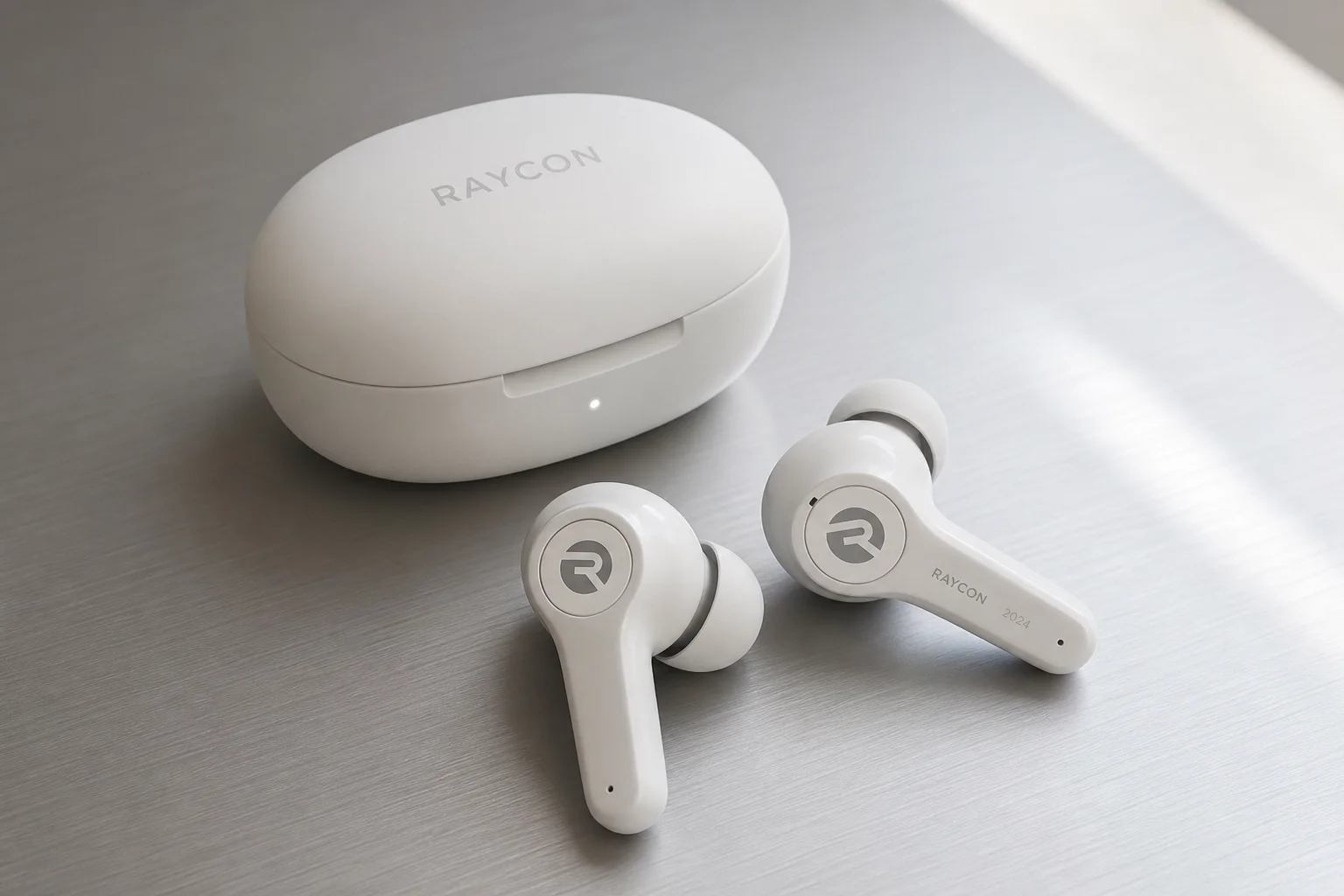 Five wireless earbuds arranged on concrete surface