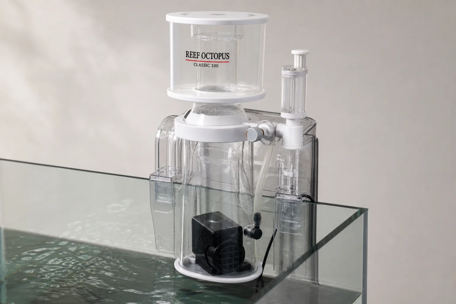 Three protein skimmers: Reef Octopus Classic 100, Classic 1000, and Tunze 9004 DC on neutral surface
