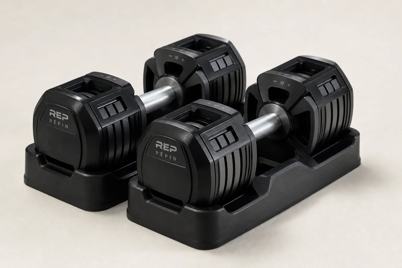 REP Pépin adjustable dumbbells with closed cage design on neutral background