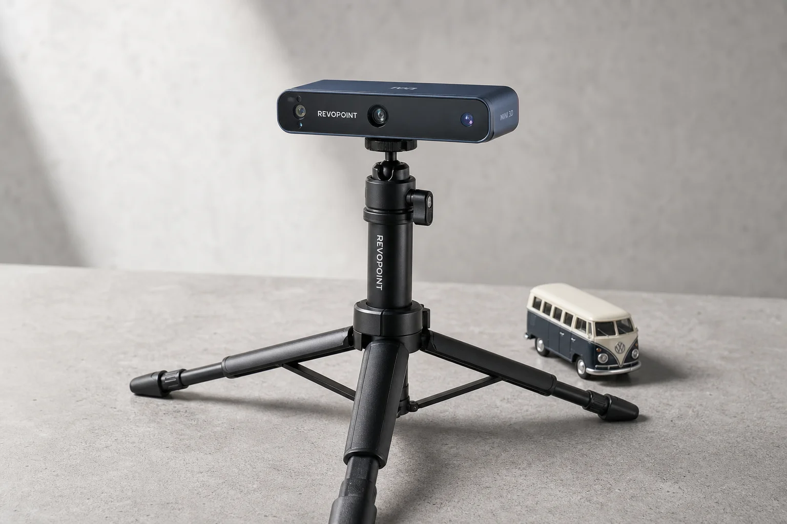 Revopoint Mini 3D scanner on tripod with sample object on concrete surface
