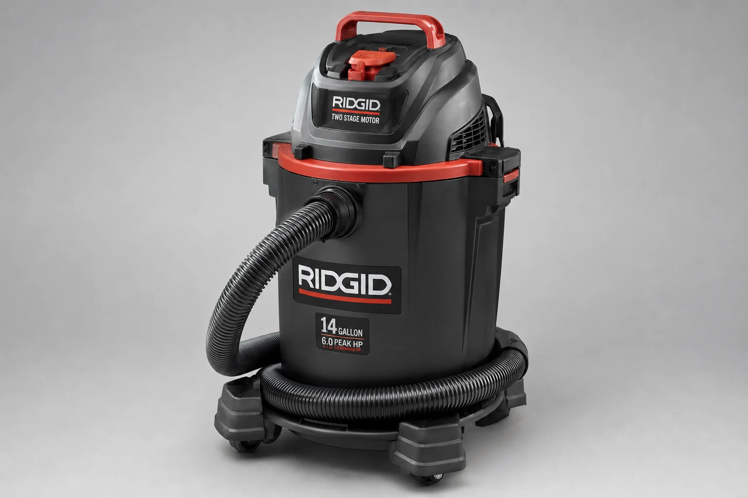 Five shop vacuums of varying sizes arranged on a concrete workshop floor
