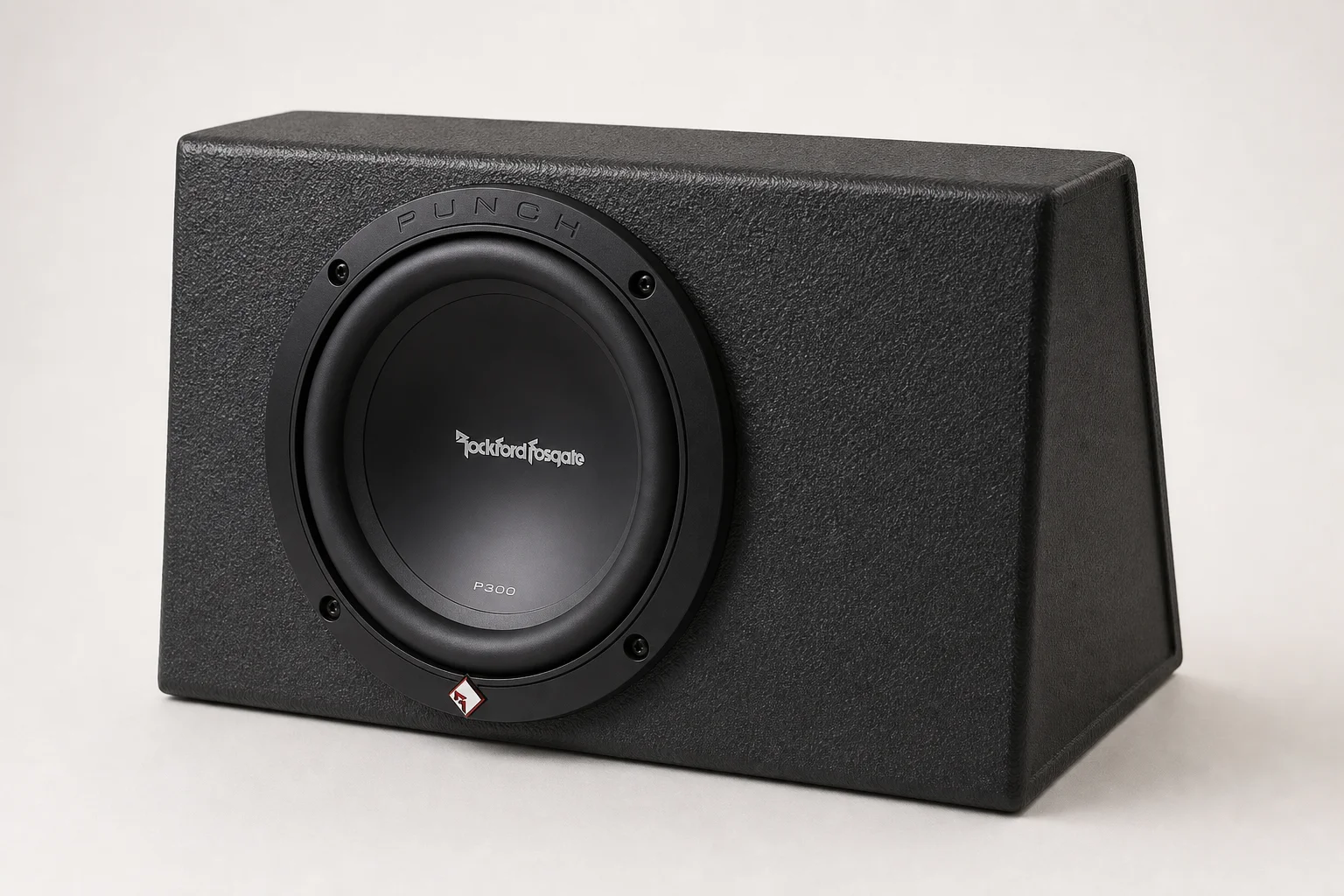 Seven car powered subwoofers of varying sizes arranged on grey surface