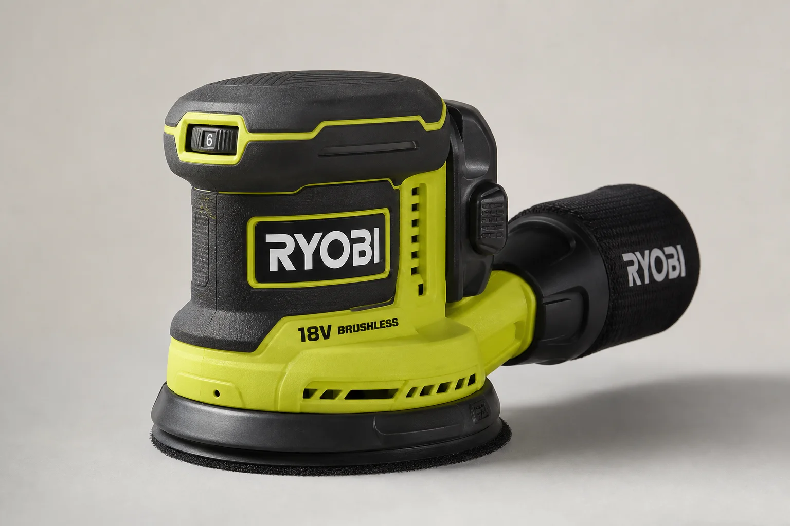 Ryobi 18V One+ cordless tools arranged on concrete surface