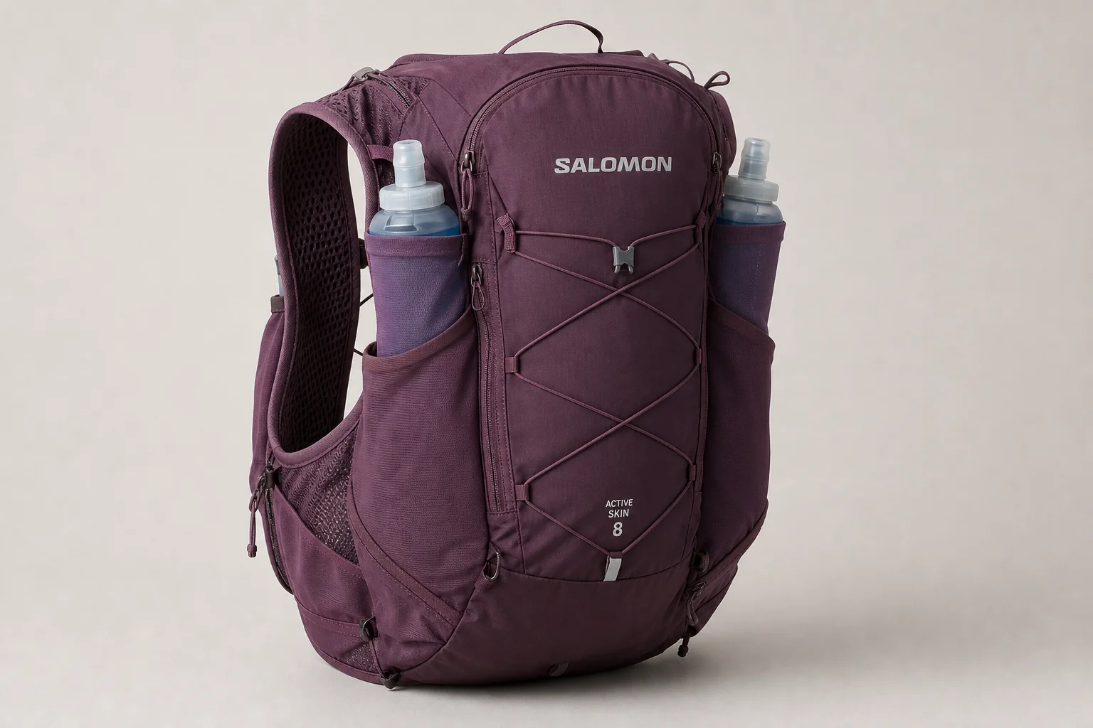 Ultralight trail running pack with organized gear laid out on neutral surface