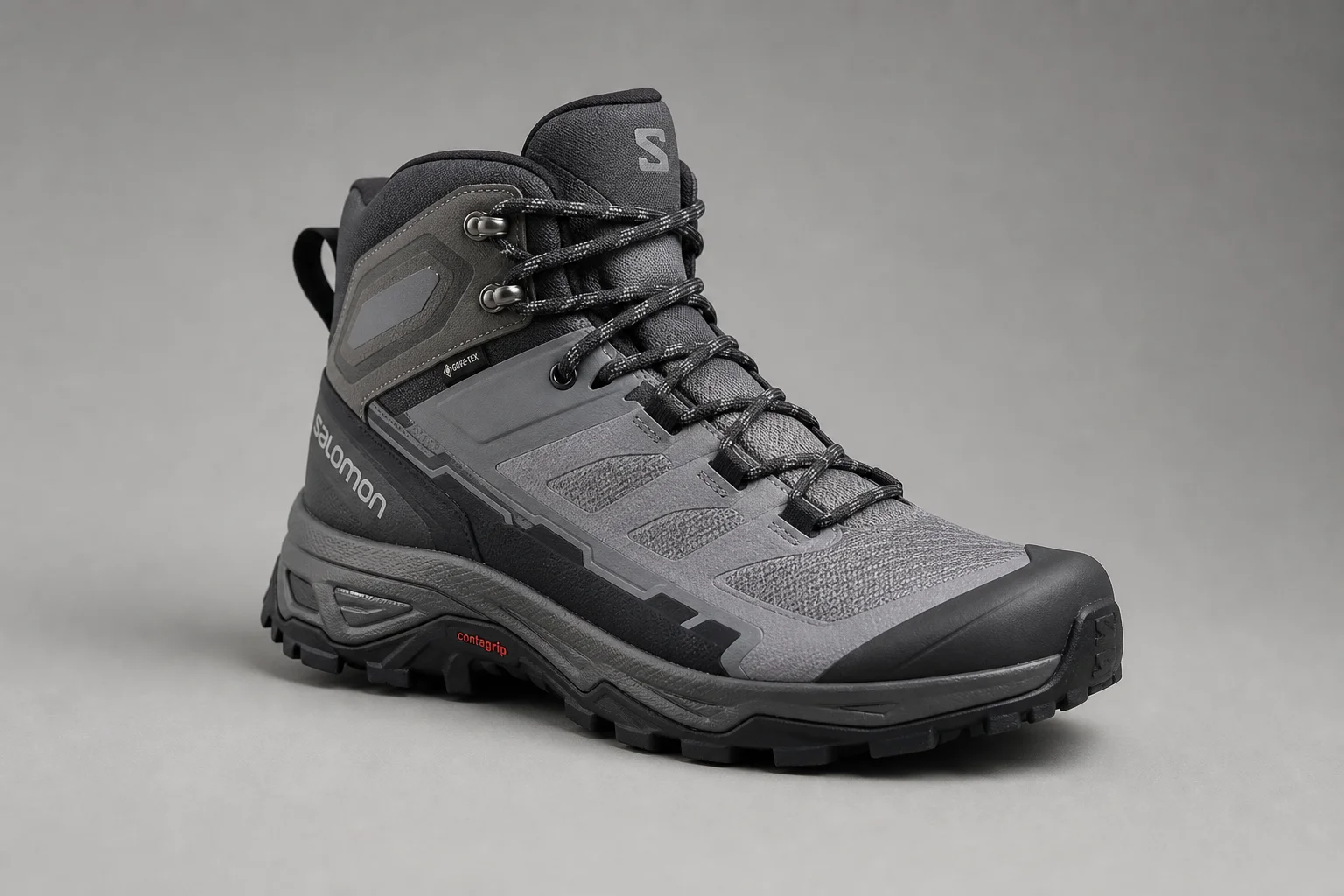 Five hiking boots arranged diagonally on concrete surface