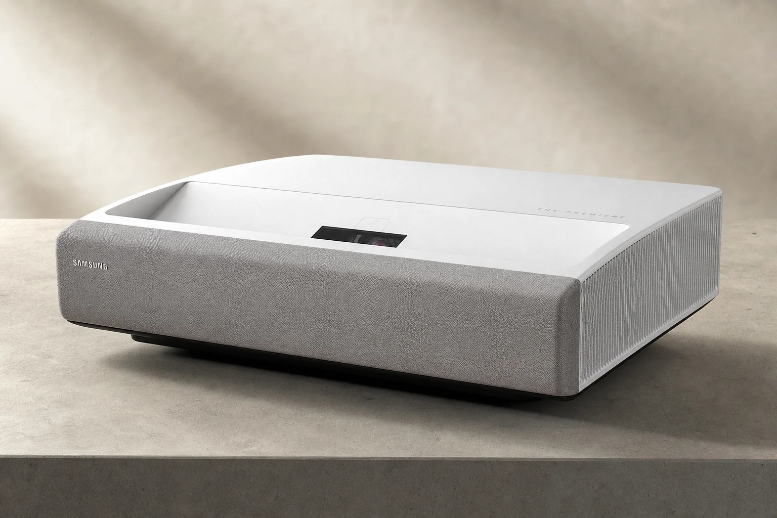 Five home theater projectors arranged by size on a concrete surface