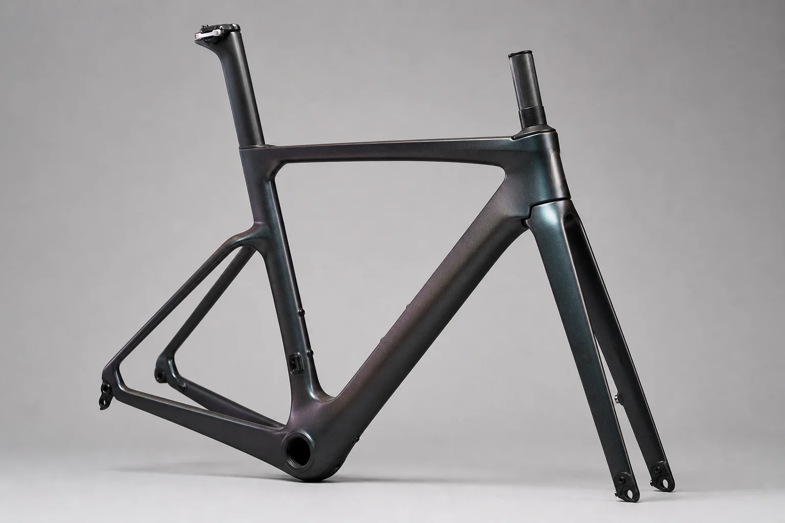 Cycling accessories flat-lay including carbon wheels, handlebar light, and bib shorts on concrete