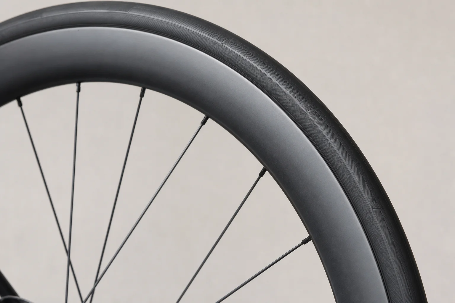 Carbon wheel rim detail showing aerodynamic profile and tire interface