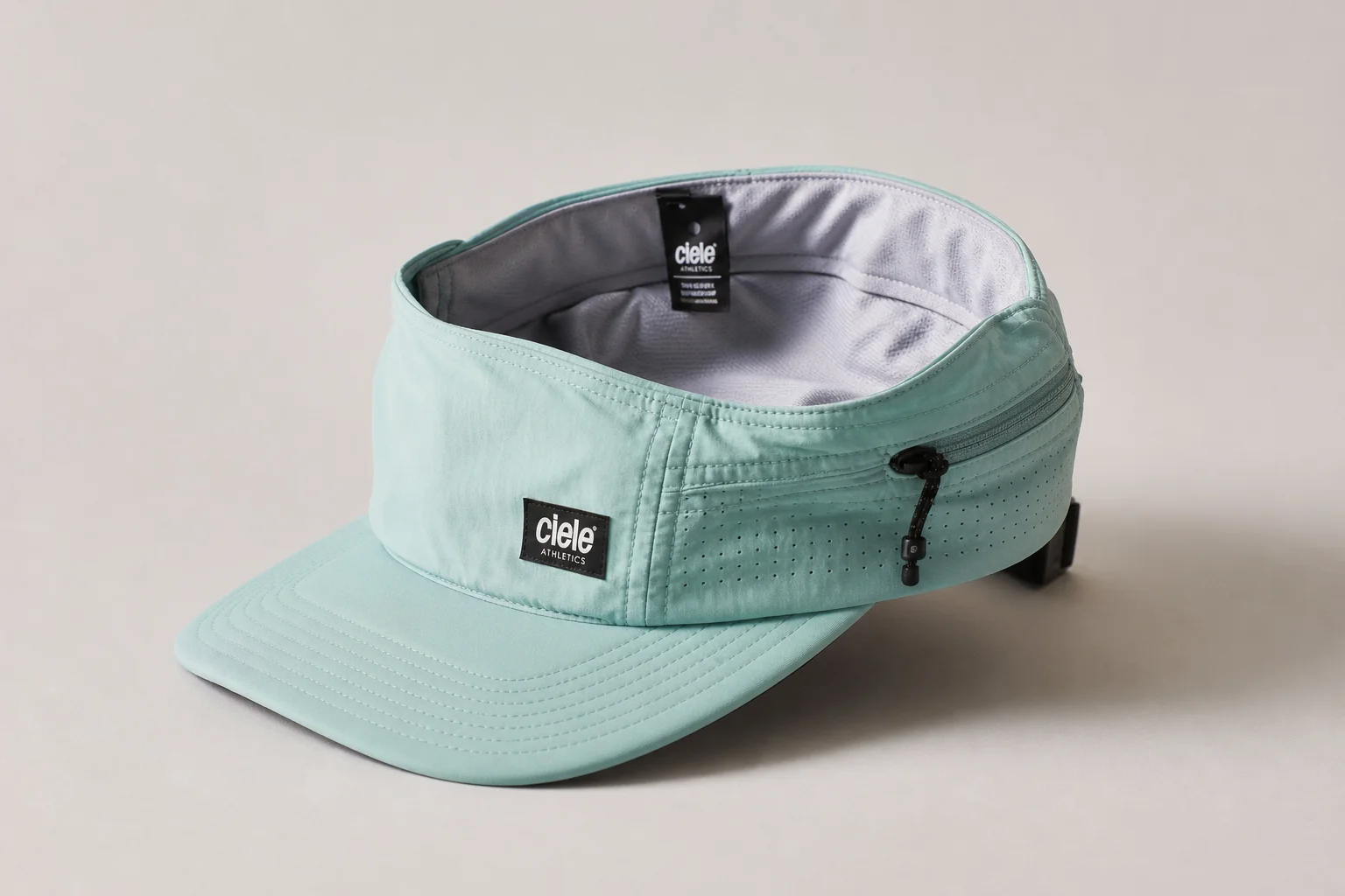 Nine running caps in various styles and colors arranged on neutral backdrop