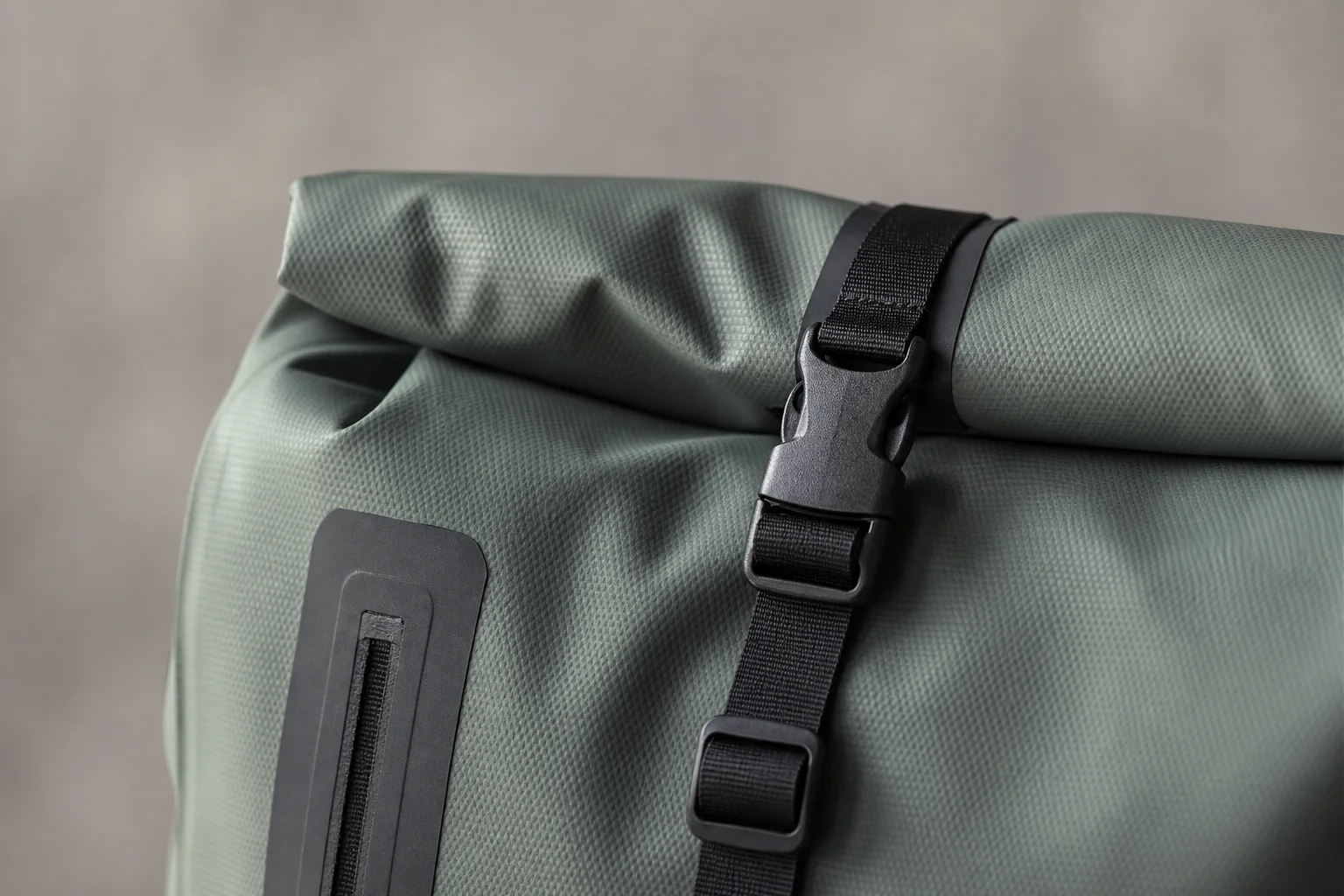 Close-up of roll-top closure mechanism on a waterproof backpack