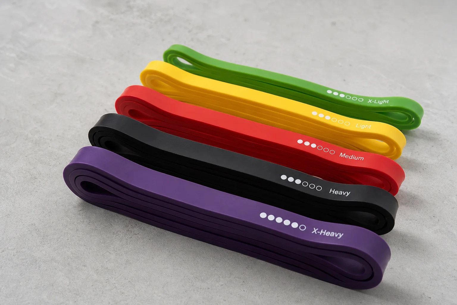 Serious Steel loop bands and Bodylastics tube bands with accessories on concrete surface