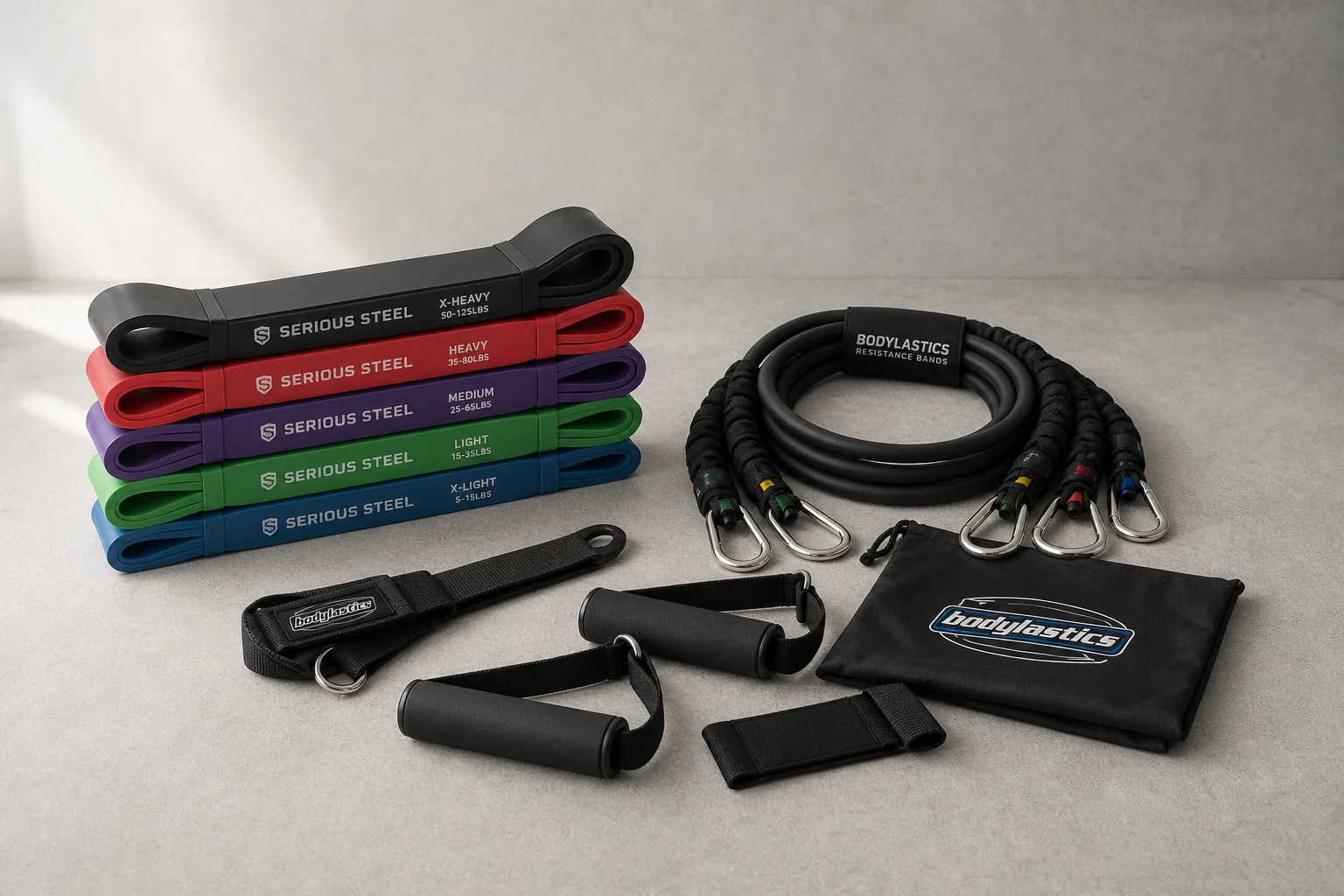 Serious Steel loop bands and Bodylastics tube bands with accessories on concrete surface