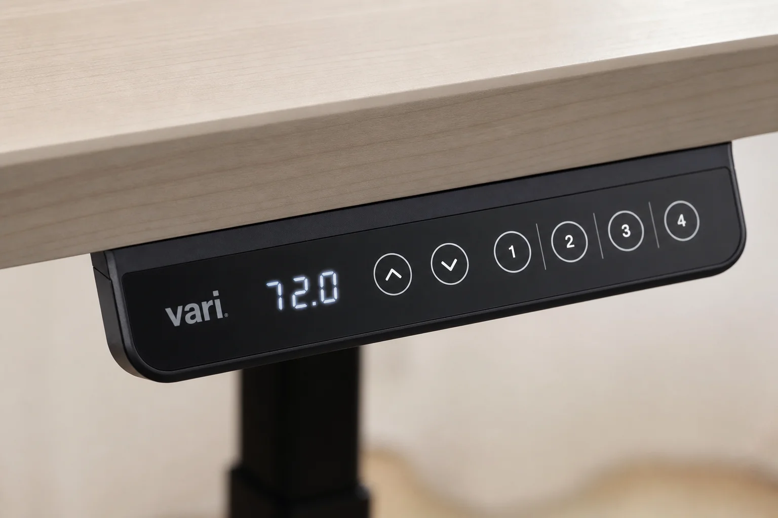 Close-up of electric desk control panel with touch buttons for height adjustment