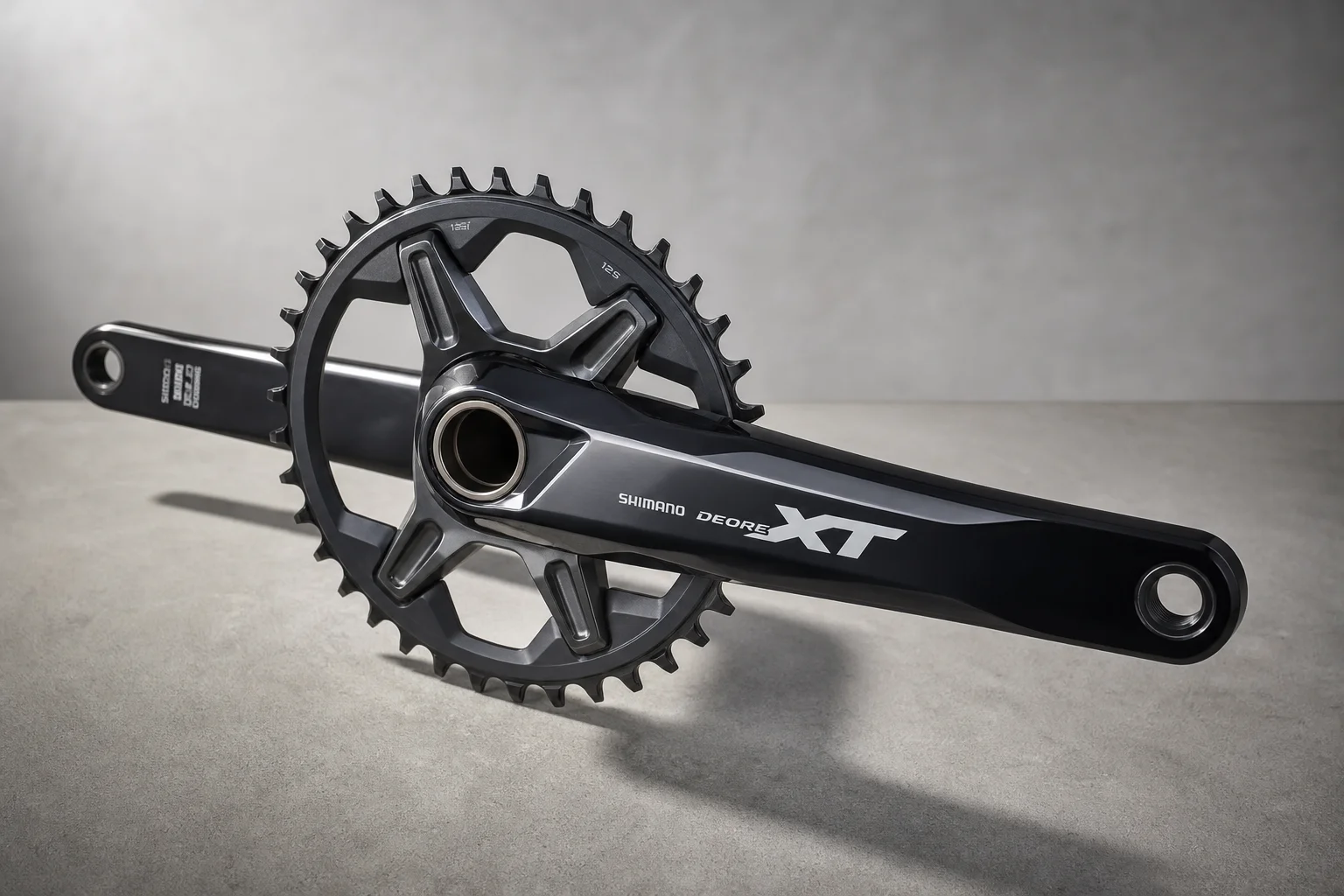 Shimano XT M8200 crankset with glossy two-tone finish on neutral grey surface