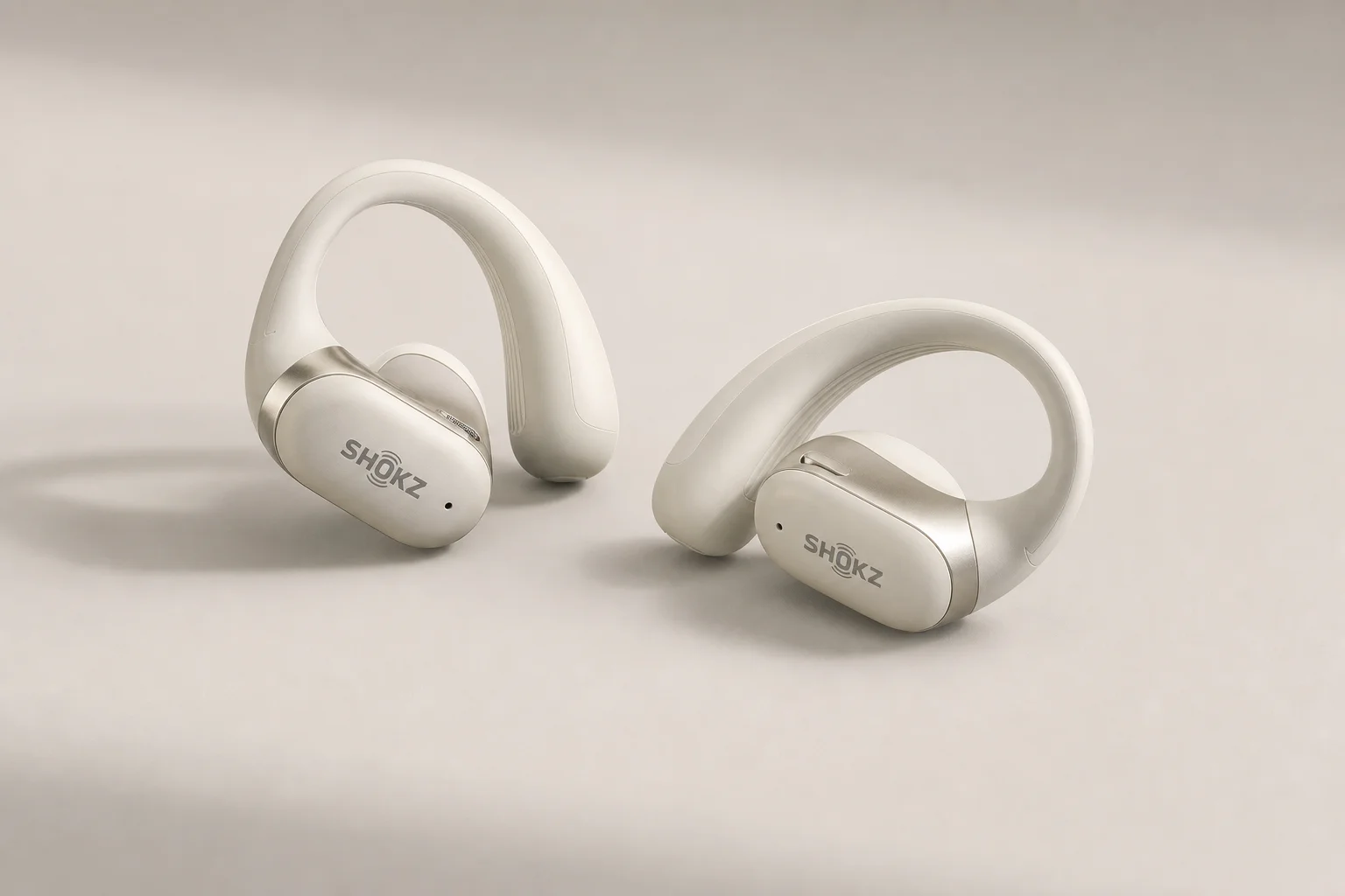 Collection of 12 true wireless earbuds arranged on concrete surface