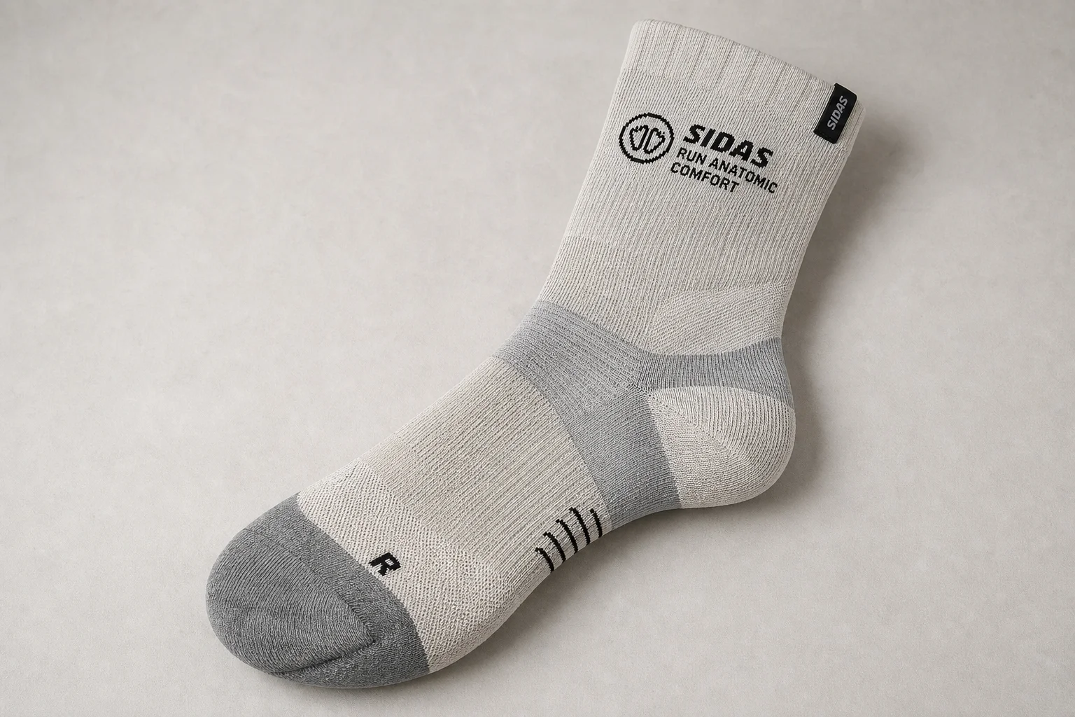 Collection of running socks in various colors and styles arranged on concrete surface
