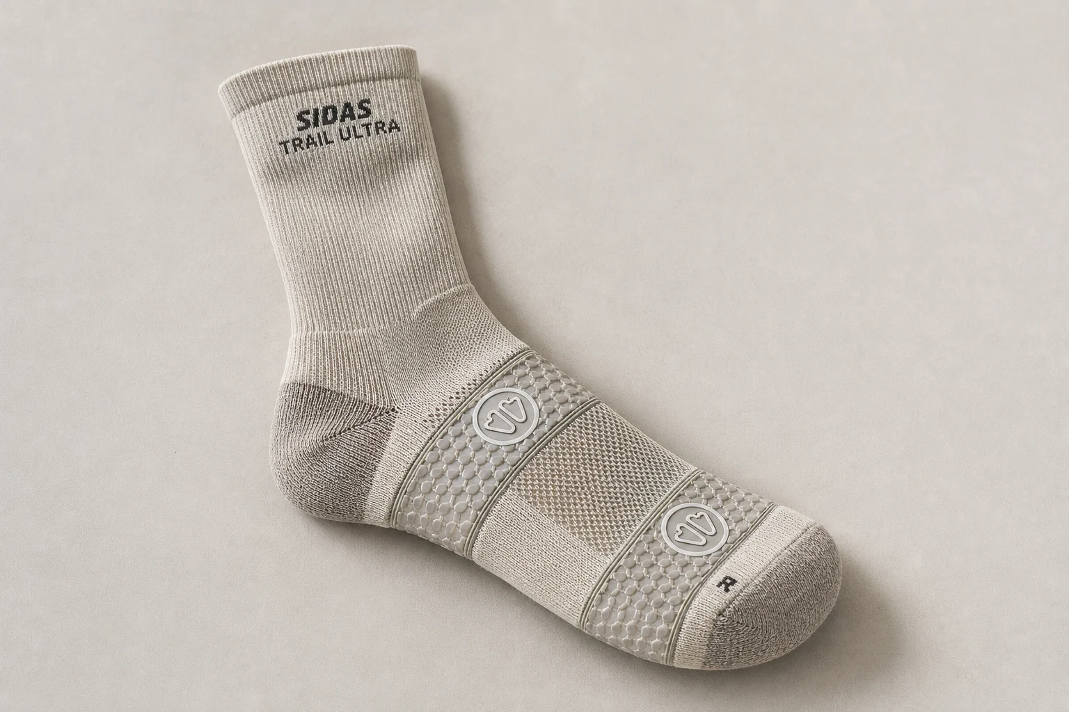 Collection of running socks in various colors and styles arranged on concrete surface