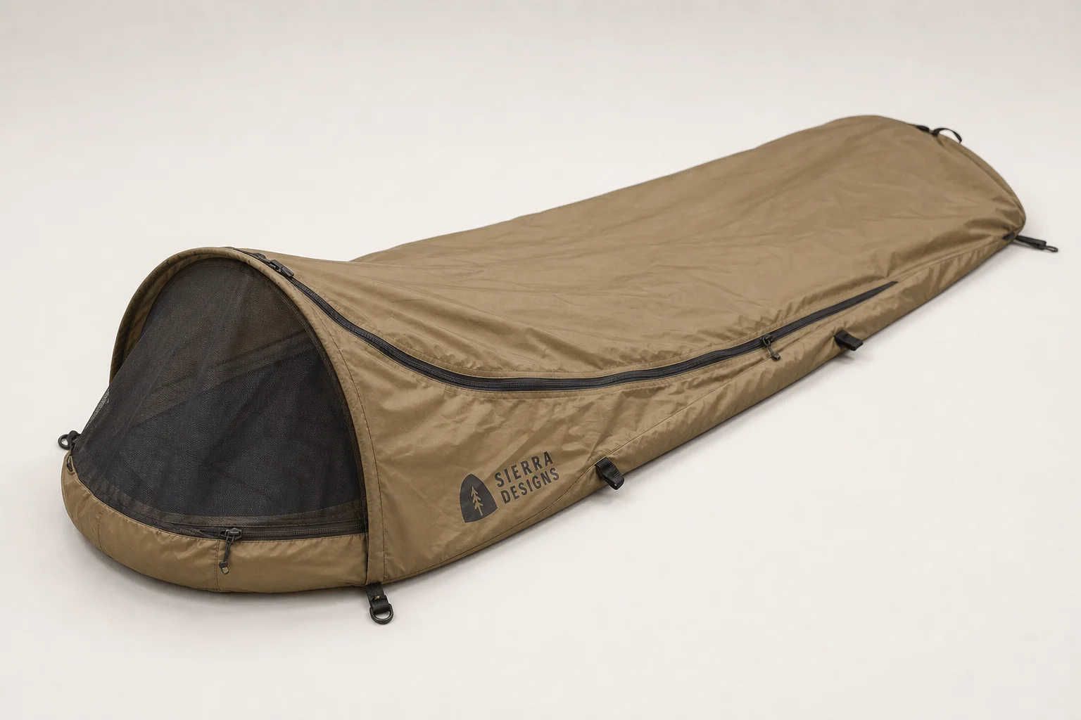 Five bivvy bags displayed in a row on concrete surface showing different designs and colors