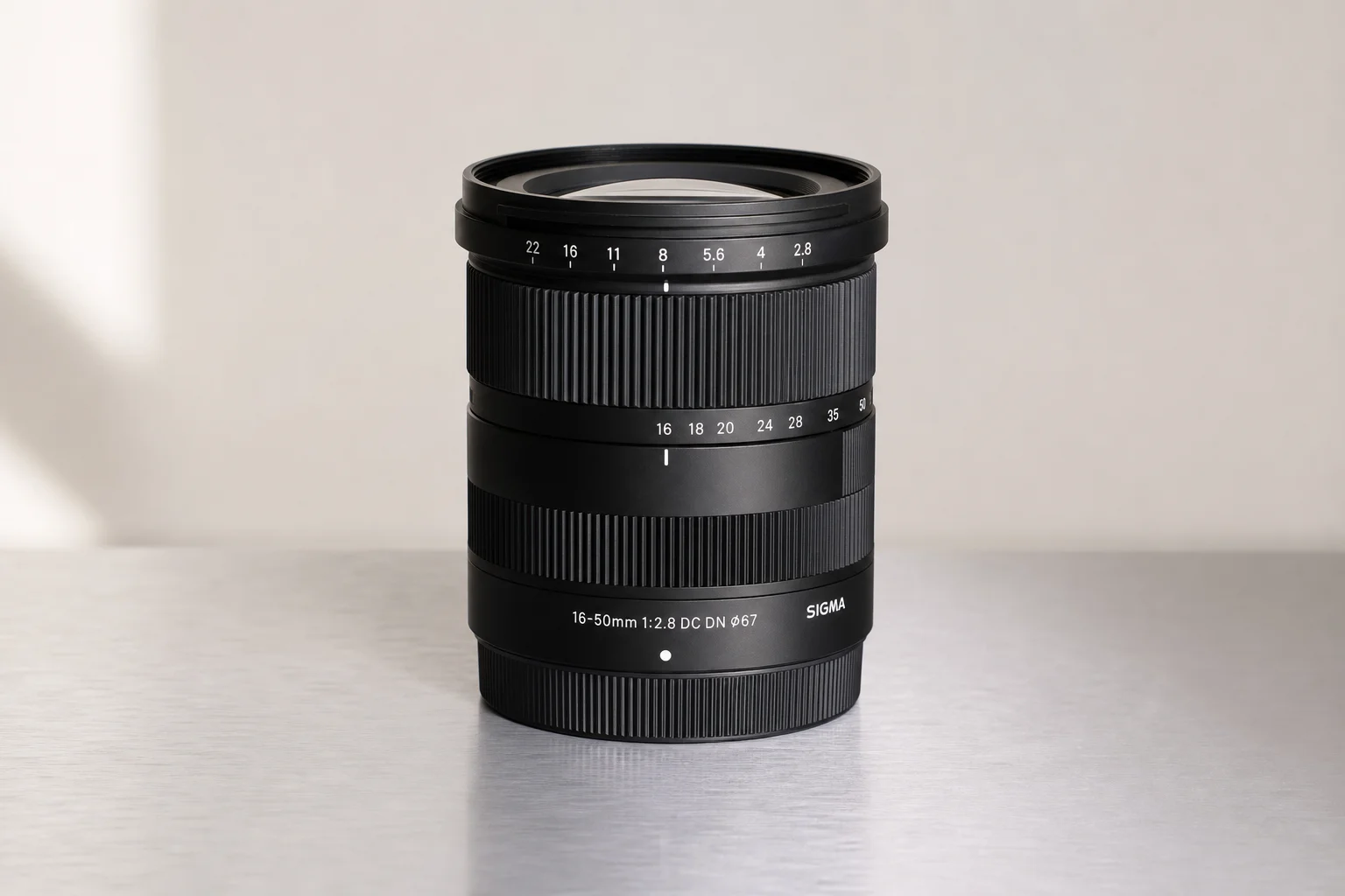 Sony A6400 mirrorless camera with attached zoom lens on brushed aluminium surface
