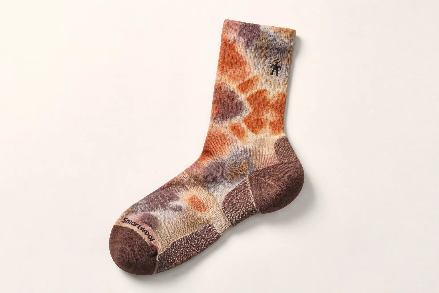 Collection of running socks in various colors and styles arranged on concrete surface