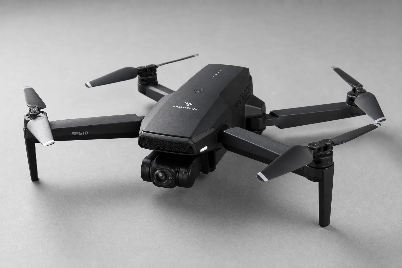 Six drones arranged by price tier on concrete surface