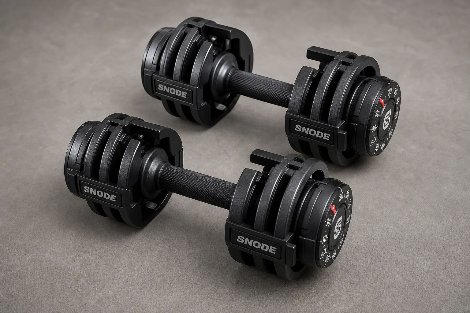 Seven different adjustable dumbbell models arranged on concrete surface