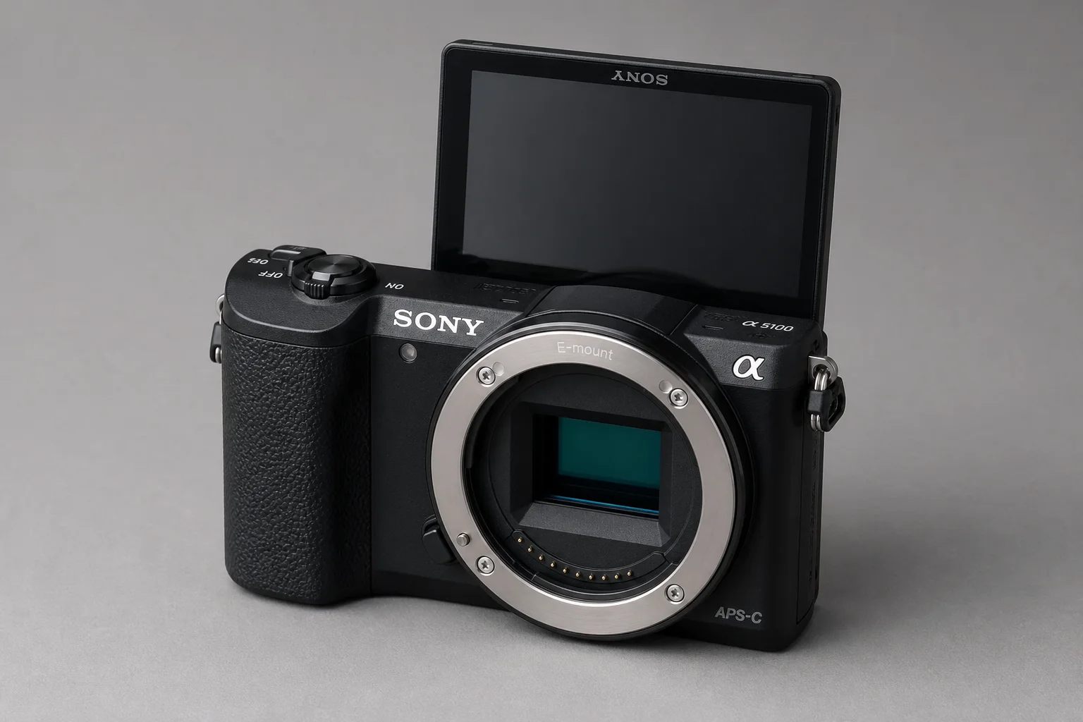Three Sony mirrorless cameras with lenses arranged on concrete surface