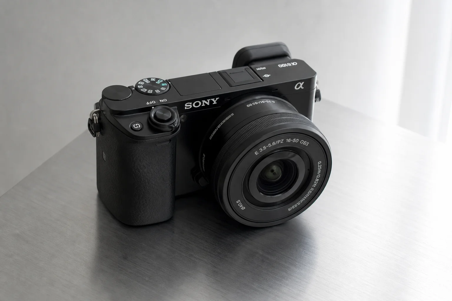 Five Sony APS-C cameras arranged on a concrete surface