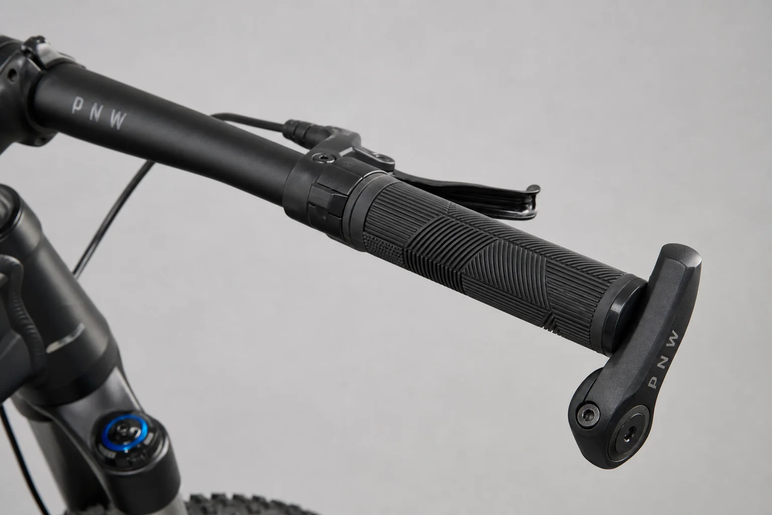 Fully loaded hardtail mountain bike with bikepacking gear on neutral backdrop