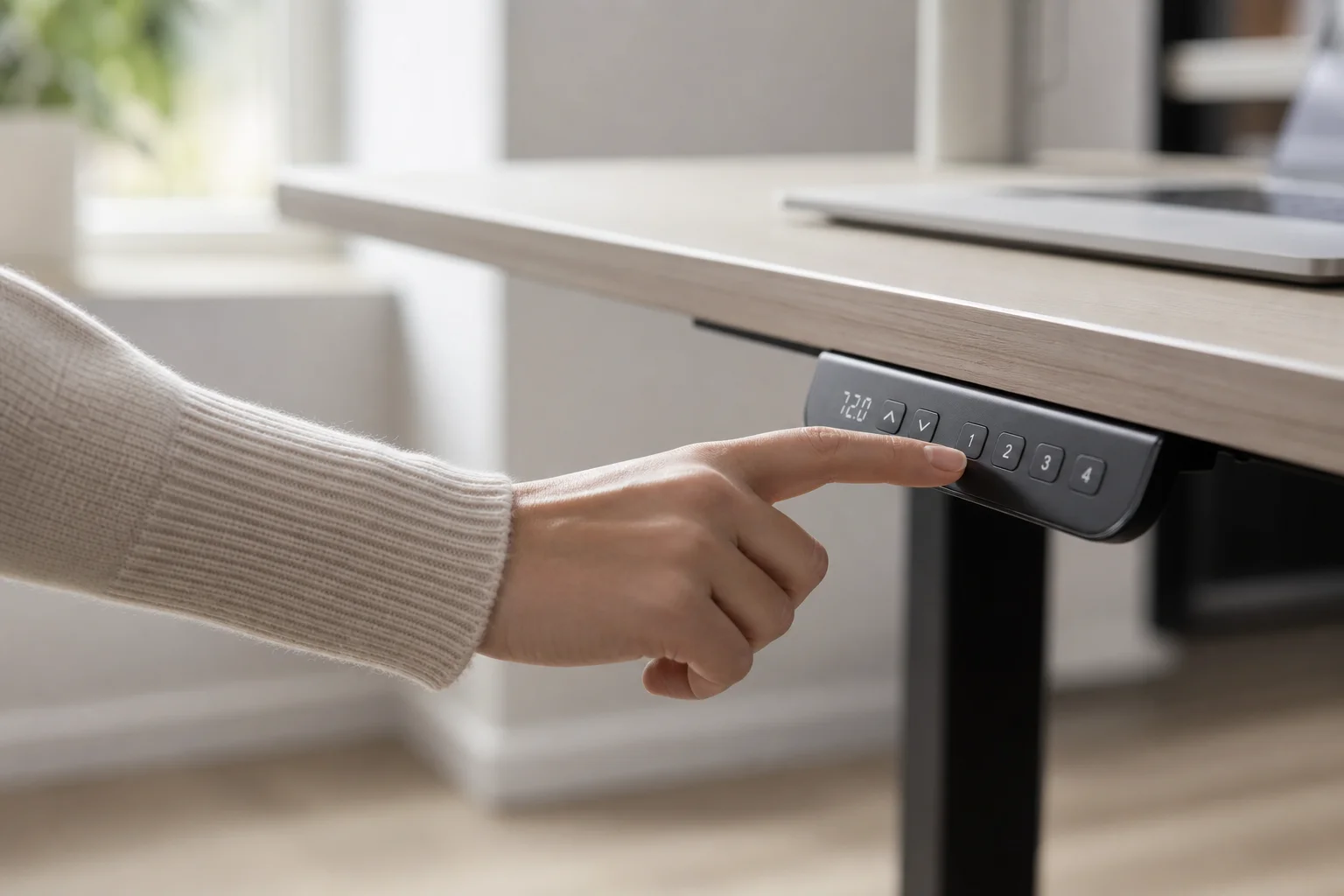 Hand adjusting standing desk control panel with preset buttons