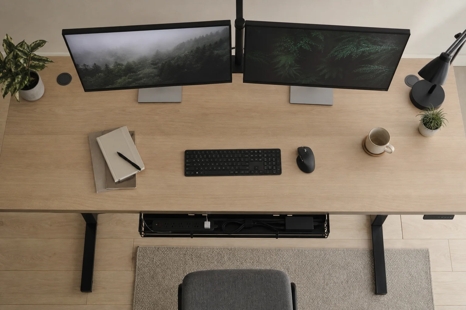 Overhead view of standing desk with dual monitors and cable management tray